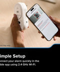 Person setting up Smart Carbon Monoxide Detector With Plug In Design And AA Battery Backup, using app on smartphone