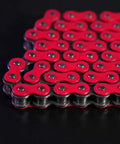 Red-lined Beefed Up Heavy Duty 420 Motorcycle Chain With Breaker 140 Link Standard Roller Drive Chain on black surface