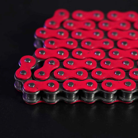 Red-lined Beefed Up Heavy Duty 420 Motorcycle Chain With Breaker 140 Link Standard Roller Drive Chain on black surface