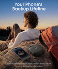 Boom Go 3i Palm Sized Portable Bluetooth Speaker with 15W Punchy Sound and Emergency Charging next to phone on rock outdoors