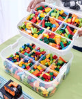 Slick 3 Tier Stackable Brick Storage Organizer With Removable Grid Trays For Lego Pieces, transparent green with colorful Lego blocks.