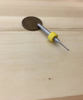 Close-up of 0.7mm micro drill bit for 3D printer nozzle cleaning shown on wooden surface with yellow handle