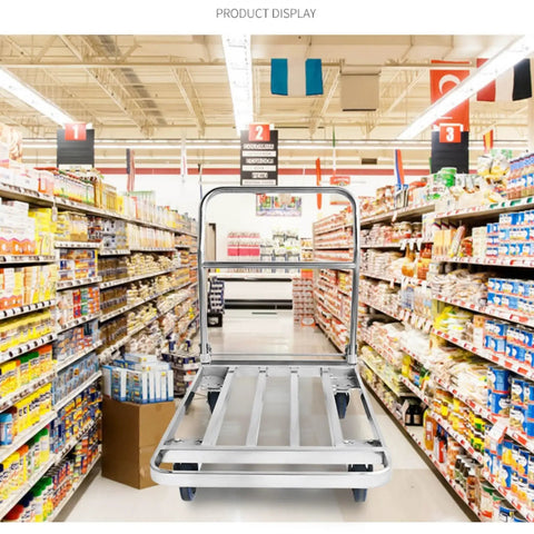 Heavy Duty Foldable Platform Push Cart With Smooth Rolling Rubber Wheels And Slick Stainless Steel Frame in a grocery aisle.