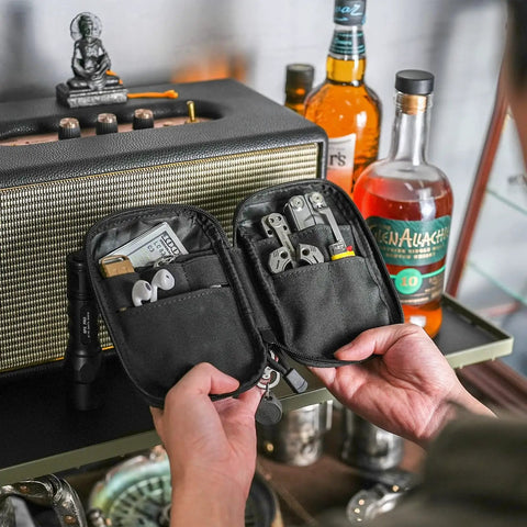 Person holding open EDC Pocket Organizer Pouch With DIY Patches Area Nylon Utility Pocket revealing multitools and gear.