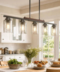 Straight Up Modern Farmhouse 5 Light Dining Room Chandelier With Dope Seeded Glass Shades Galvanized Steel Island Ceiling Fixture Lighting Top Shelf Kitchen Vibes in a bright kitchen setting.