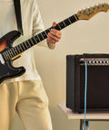 Guitarist playing next to 40 Watt 1x10 Guitar Combo Amp With Spring Reverb, 10 Inch 4 Ohm Speaker, Stage Right Series for practice.