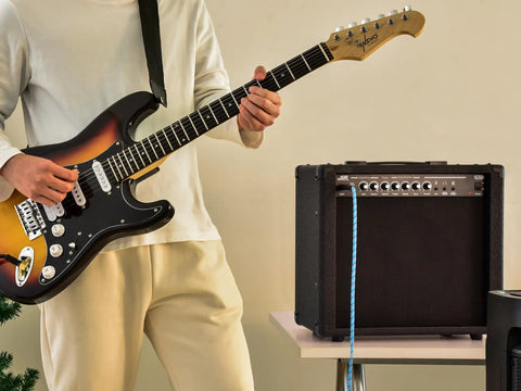 Guitarist playing next to 40 Watt 1x10 Guitar Combo Amp With Spring Reverb, 10 Inch 4 Ohm Speaker, Stage Right Series for practice.