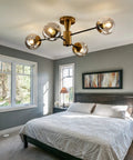 Modern Four Light Gold Glass Globe Ceiling Light Fixture Mid Century Semi Flush Mount in bedroom setting