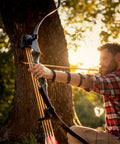 Archer using recurve bow at sunset, potentially with Beefy 4.2mm Arrow Nocks 30 Pack White Insert Nocks Replacement For Hunting And Target Archery