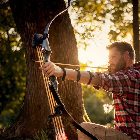 Archer using recurve bow at sunset, potentially with Beefy 4.2mm Arrow Nocks 30 Pack White Insert Nocks Replacement For Hunting And Target Archery
