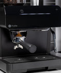 Next Level Semi Automatic Espresso Machine With Built In Grinder Steam Frother Featuring Italian Made 15 Bar Pump For Straight Up Perfect Shots Plus Wifi Connected Custom Brewing In Slick Black showing the grinder and portafilter.