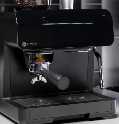 Next Level Semi Automatic Espresso Machine With Built In Grinder Steam Frother Featuring Italian Made 15 Bar Pump For Straight Up Perfect Shots Plus Wifi Connected Custom Brewing In Slick Black showing the grinder and portafilter.