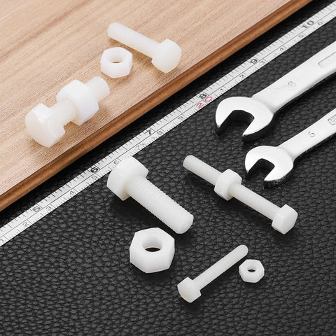 Slick White Nylon M5 Hex Screw And Nut Set, 25 Pair M5X50mm Bolts Fasteners with wrenches on black leather surface.