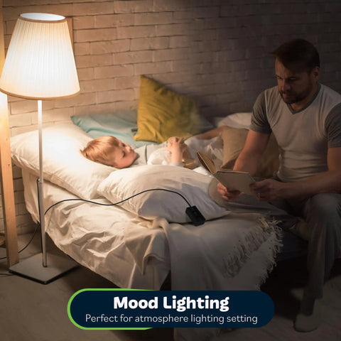 Man reading to child in bed, lamp with Table Top Plug In Dimmer For Lamps With Quiet Slide Control Dims 10 To 100 Percent visible