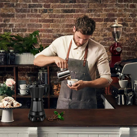 Barista pouring coffee with an Electric Moka Pot 6 Cup Coffee Maker for quick espresso Italian style on counter