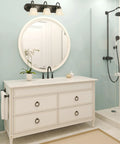 Three Light Dimmable Vanity Light In Oil Rubbed Bronze With Frosted Glass Shades, 24 Inch Wide, Large Backplate, installed in bathroom.