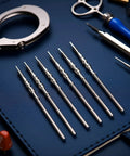 5Pcs Silver Stainless Steel Movement Watch Stem Crown Kit For NH35 NH36 NH38 NH39 Movements Replacement Parts And Repair Tools Kit Ideal For Quick Durable Easy Fit Repairs displayed on a blue surface.