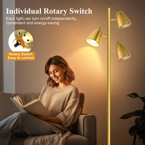 Three Arm Floor Lamp With 360 Degree Adjustable Reading Arms In Brushed Gold next to a woman reading on a couch