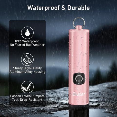Pink EDC Rechargeable Keychain Flashlight 360 Lumen Mini Pocket Light showcasing waterproof aluminum design in rain.
