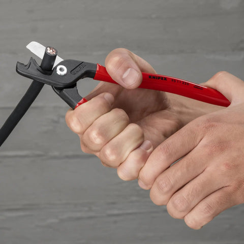 Hands using StepCut XL Cable Shears 9 Inch, High Leverage Joint, cutting solid copper cable