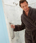 Man testing 24 Inch Handicap Grab Bar For Bath And Shower With Curled Grip No Slip Brushed Nickel Heavy Duty Stainless Steel