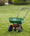 Edge Guard Mini Broadcast Spreader With Calibrated Settings And Wheels on lawn, ideal for 5,000 sq ft spreading
