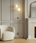 Equinox LED Wall Sconce Indoor Plug In Light For Bedroom And Bathroom With Glass Globe Shades Industrial Wall Mounted Fixture And On Off Switch Gold Finish Perfect For A Modern Home Vibe next to armchair in elegant room.