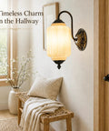 RONGHUAFUGUI Vintage Modern Wall Sconce with Amber Glass illuminates a cozy hallway with warm light and elegant design.
