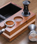Espresso Tamper 51mm With Dual Spring Load Delivers 30 Lb Constant Pressure on a wooden knock box, ripple base visible