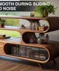 Wooden shelving unit with smooth sliding doors, displaying glass jars and plants. Mid-century modern design, ideal for living rooms.