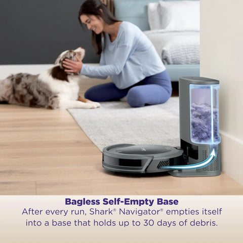 Robot Vacuum With Self Empty Base And 60 Day Bagless Capacity in use next to dog and person on carpet floor.