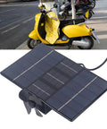 Badass Solar And Wind Power Generator For Electric Bikes features a solar panel with a fan, ideal for recharging bike batteries.
