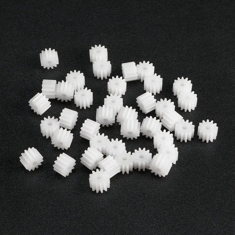 40 Piece Plastic Gear Set With 12 Tooth Model 122A Reduction Worm Gears, loose on black surface, for RC Cars and Robot Motors upgrade.