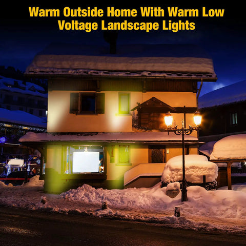 Snow-covered house at night lit by 16 Pack 3W LED Well Lights For Low Voltage Outdoor Landscape Lighting Kit