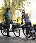 Cyclists using Waterproof Bike Pannier Bag 25L With Quick Release TPU Coating And Reflective Design for touring and commuting.