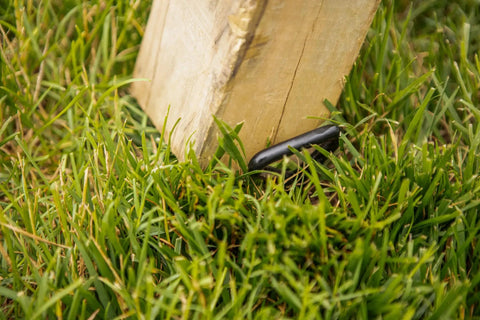 Playset Anchor Kit For Swing Sets Heavy Duty Ground Anchors installed on wooden play structure in grass for stability and safety