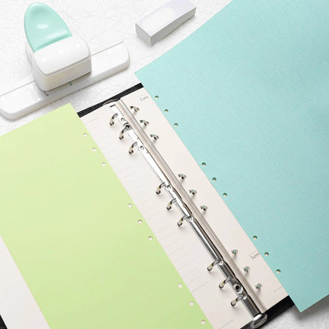 Go To 3 Hole Punch And 12 Piece Metal Ring Binder Set For A5 To A8 Notebooks in green featuring binder open with pastel pages