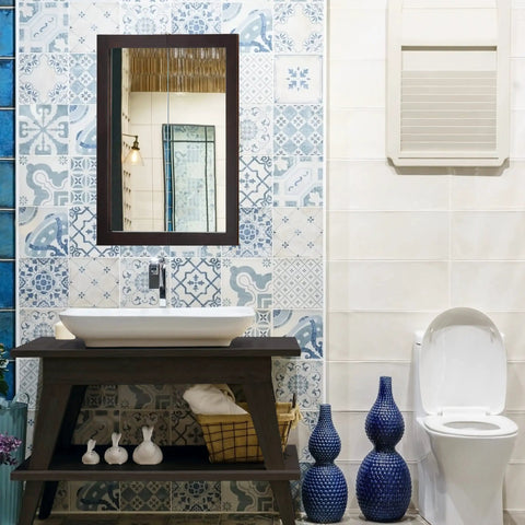 Bathroom with wall-mounted espresso medicine cabinet with mirrored doors, above a sink and patterned blue tiles.