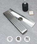 12 Inch Linear Shower Drain With Removable Square Panel, AISI 304 Stainless Steel Brushed Floor Drain With Adjustable Feet, Hair Strainer, 2 Inch Outlet And X Shaped Diversion Groove For No Clog displayed on tile surface