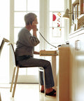 Person wearing Sacroiliac SI Joint Hip Belt for Sciatic Pain Relief in Lower Back Pelvis and Leg Pain, seated and talking on phone