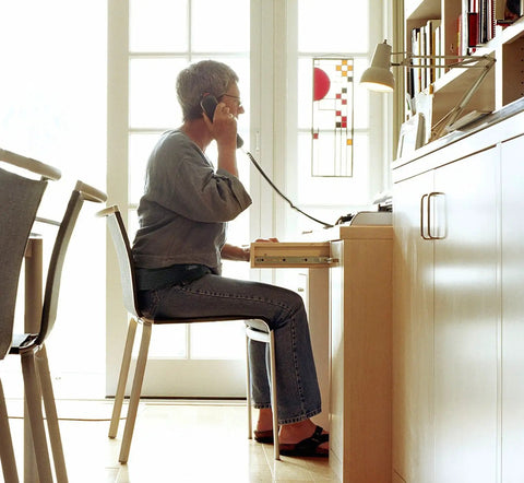 Person wearing Sacroiliac SI Joint Hip Belt for Sciatic Pain Relief in Lower Back Pelvis and Leg Pain, seated and talking on phone