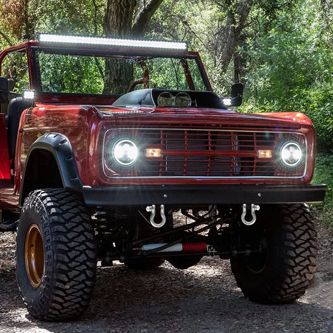 Front view of a red vehicle with off-road tires, showcasing a 1 1/8 Inch D Ring Shackle 9 Point 5 Ton Rated Heavy Duty Screw Pin Anchor Rigging Hardware.