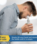 Man using BPA Free Portable Eye Wash Station With Mirror, Grab And Go Ready, OSHA Approved, Wall Mounted First Aid Eye Wash Kit