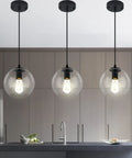 Industrial Farmhouse Globe Pendant Light Fixture With Adjustable Cord Black Hanging Ceiling Chandelier illuminating kitchen island.