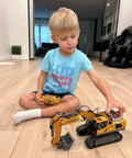 Child playing with 11 Channel RC Excavator Toy For Kids 3-12, Metal Construction Truck indoors