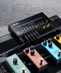 True Isolated Guitar Pedal Power Supply With Ten Outputs Quiet Noise Free Rig Power 9V 12V And 18V DC Options USB Port Short Circuit Protection Keeps Your Effects Pedals Clean And Stable On Stage Or In The Studio on pedalboard with colorful pedals