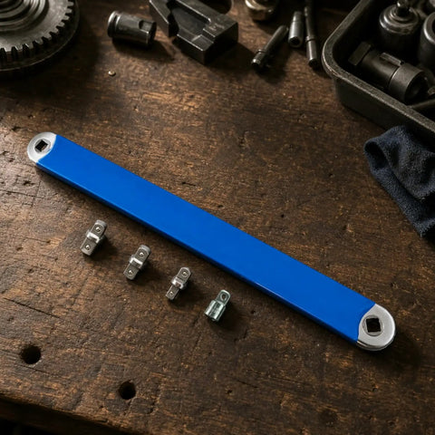 Badass Offset Extension Wrench With Swappable Drive Adapters And Quick Socket Attachments Built From Tough High Carbon Steel No Hustle Multi Tool For Cramped Spaces Or Gunked Up Bolts Orange, blue wrench with adapters on a wooden workbench.