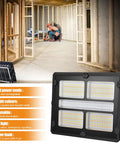 Super Bright Rechargeable Solar Work Light Packed With Huge Battery For All Your Camping Emergencies Storm Prep And Power Outages Portable Waterproof Lantern With Handy Hook And Stand Dimmable Settings Make It A Must Have, showcasing dual power modes, dimmable settings, and multiple light colors in a construction setting.