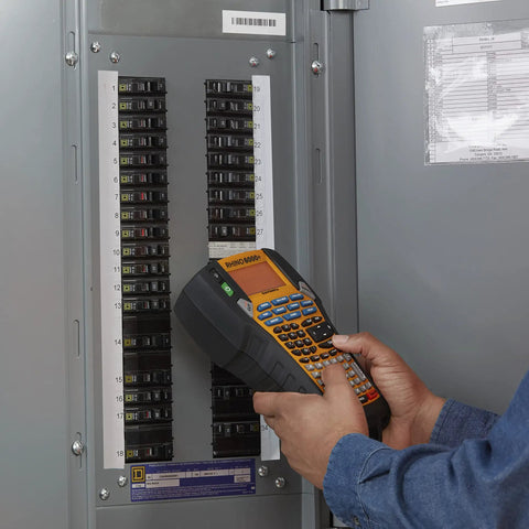 Person using the Straight Up Heavy Duty Jobsite Computer Connected Label Maker With Rechargeable Battery And Hard Case to label a circuit breaker panel.