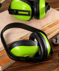 Six Piece Kids Noise Reduction Earmuffs And Hearing Protection Headphones Adjustable Padded Defender, green on wooden surface